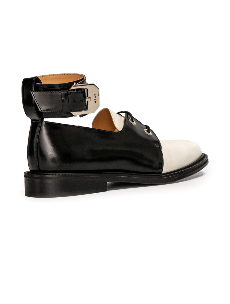 CWEN lace up shoe in black and white glossed leather, with detachable ankle strap and large silver buckle back view