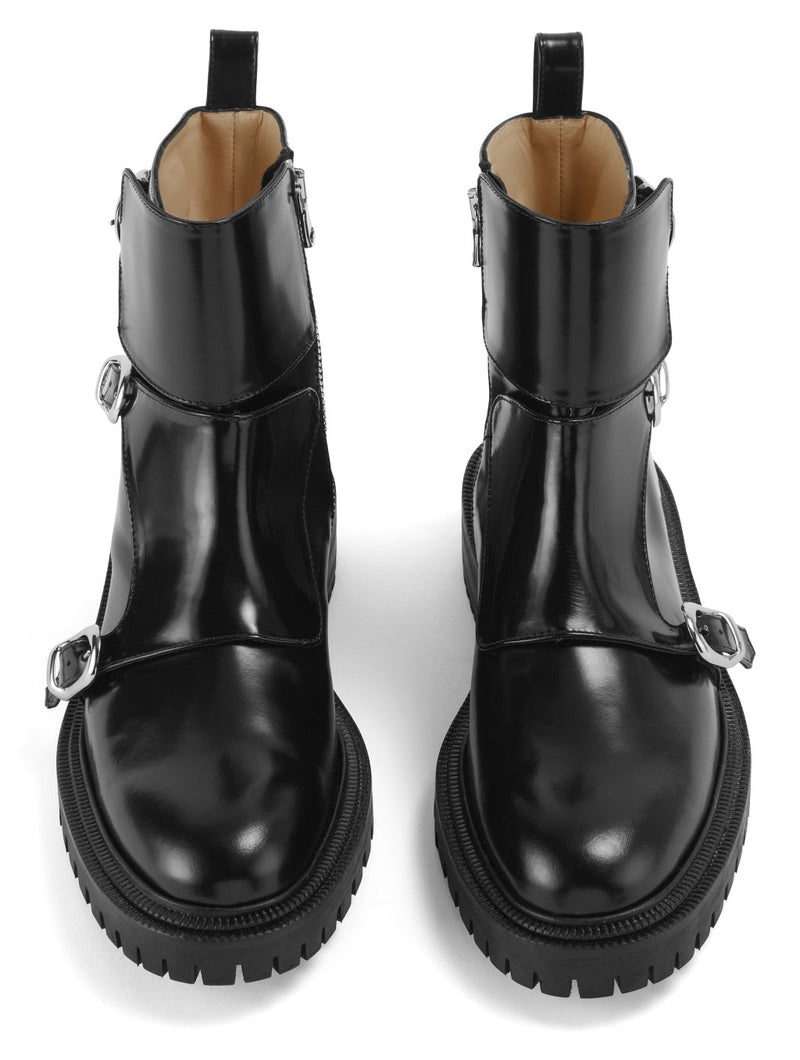 Front view of CWEN ankle glossed leather black boots, with double monk strap, light tan colour lining and a ridged rubber sole.