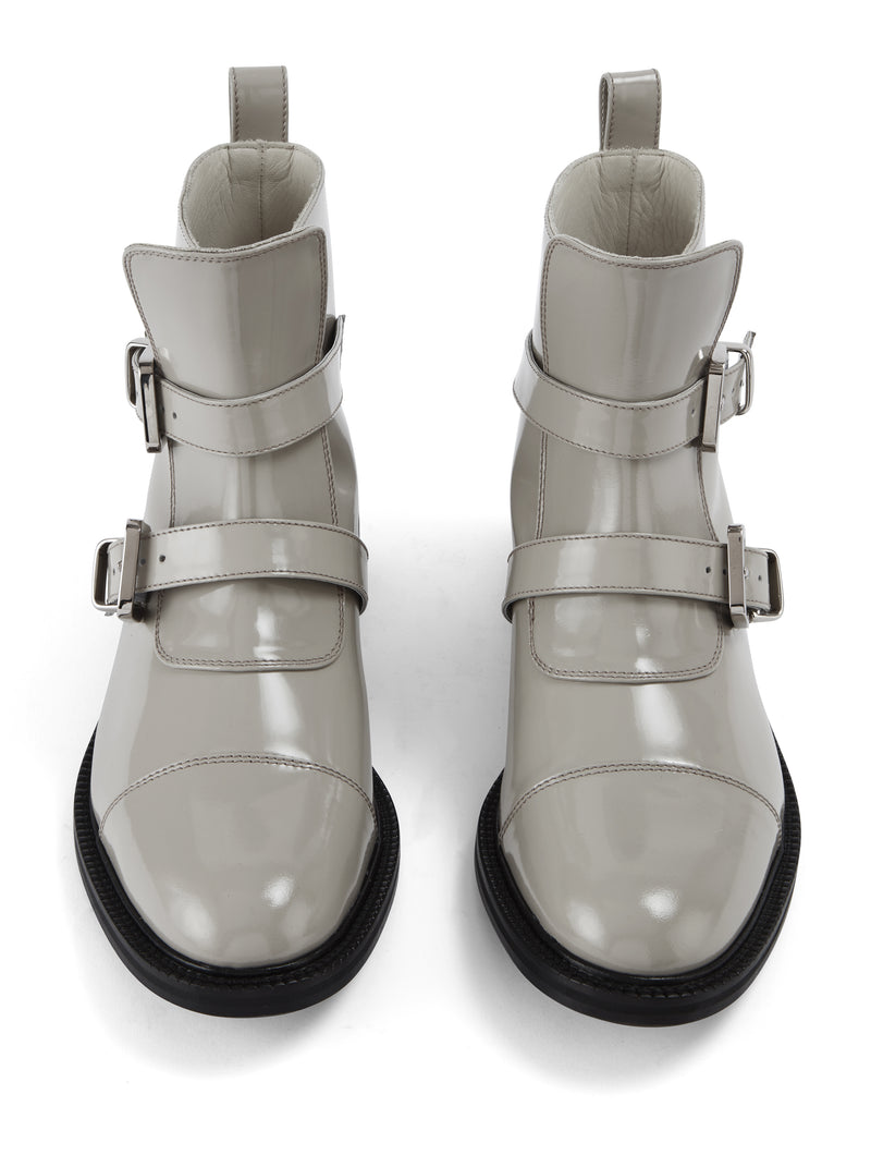 Front view of CWEN ankle glossed leather light grey boots, with two straps, two silver buckles, light tan colour lining and a leather sole