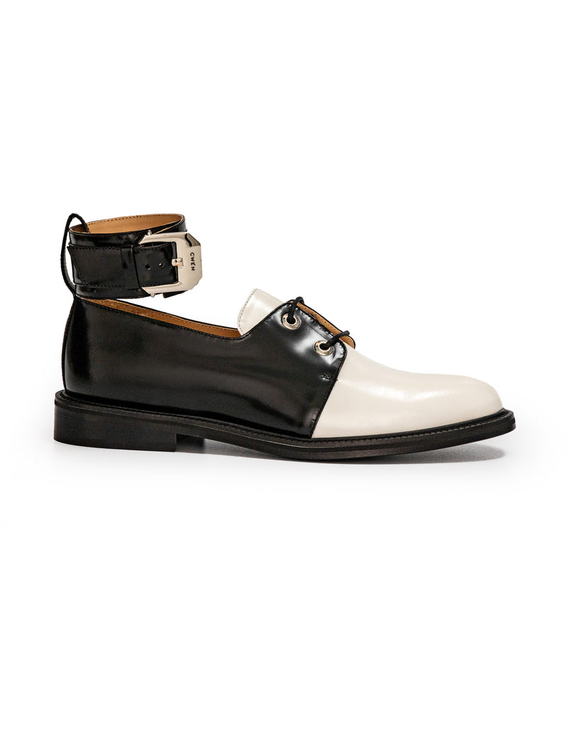 CWEN lace up shoe in black and white glossed leather, with detachable ankle strap and large silver buckle side view